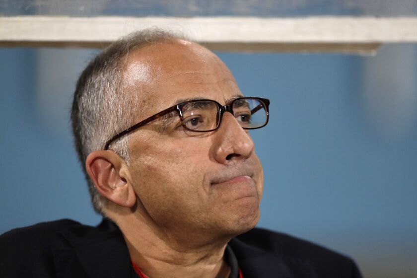 FILE - In this Oct. 10, 2017, file photo, Carlos Cordeiro, vice president of U.S. soccer, watches warmups from the team bench ahead of the start of the U.S.'s final World Cup qualifying match against Trinidad and Tobago at Ato Boldon Stadium in Couva, Trinidad. Cordeiro, the current U.S. Soccer Federation President, says the governing body was surprised when womens national team players sued alleging gender discrimination. Cordeiro says the USSF is reviewing suit and he has spoken with some of the players this week and hopes for continued conversation. (AP Photo/Rebecca Blackwell, File)