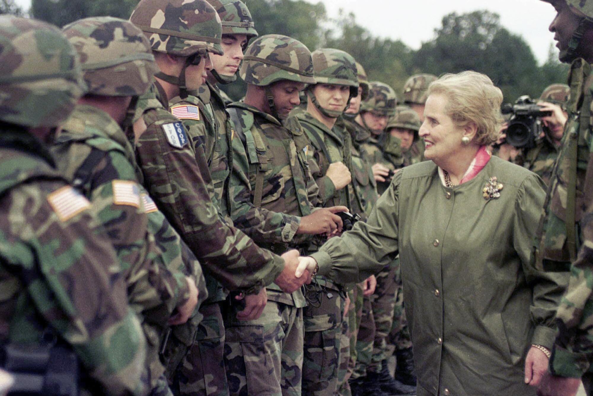 Madeleine Albright, then-U.S. secretary of State, shakes hands with U.S soldiers in 1998.