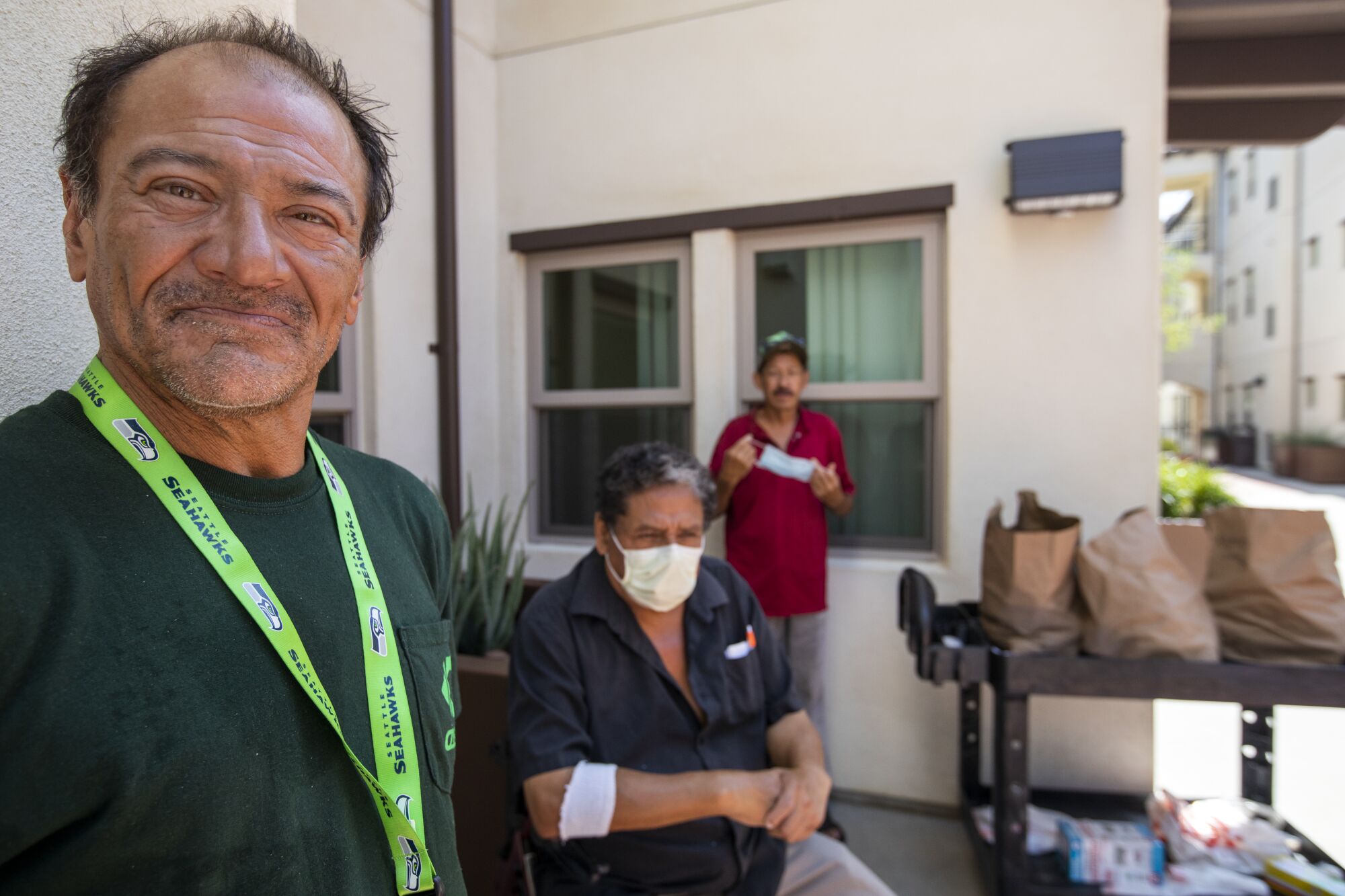 Residents wait in the courtyard of their new apartment complex in Los Angeles to pick up food from a food bank.