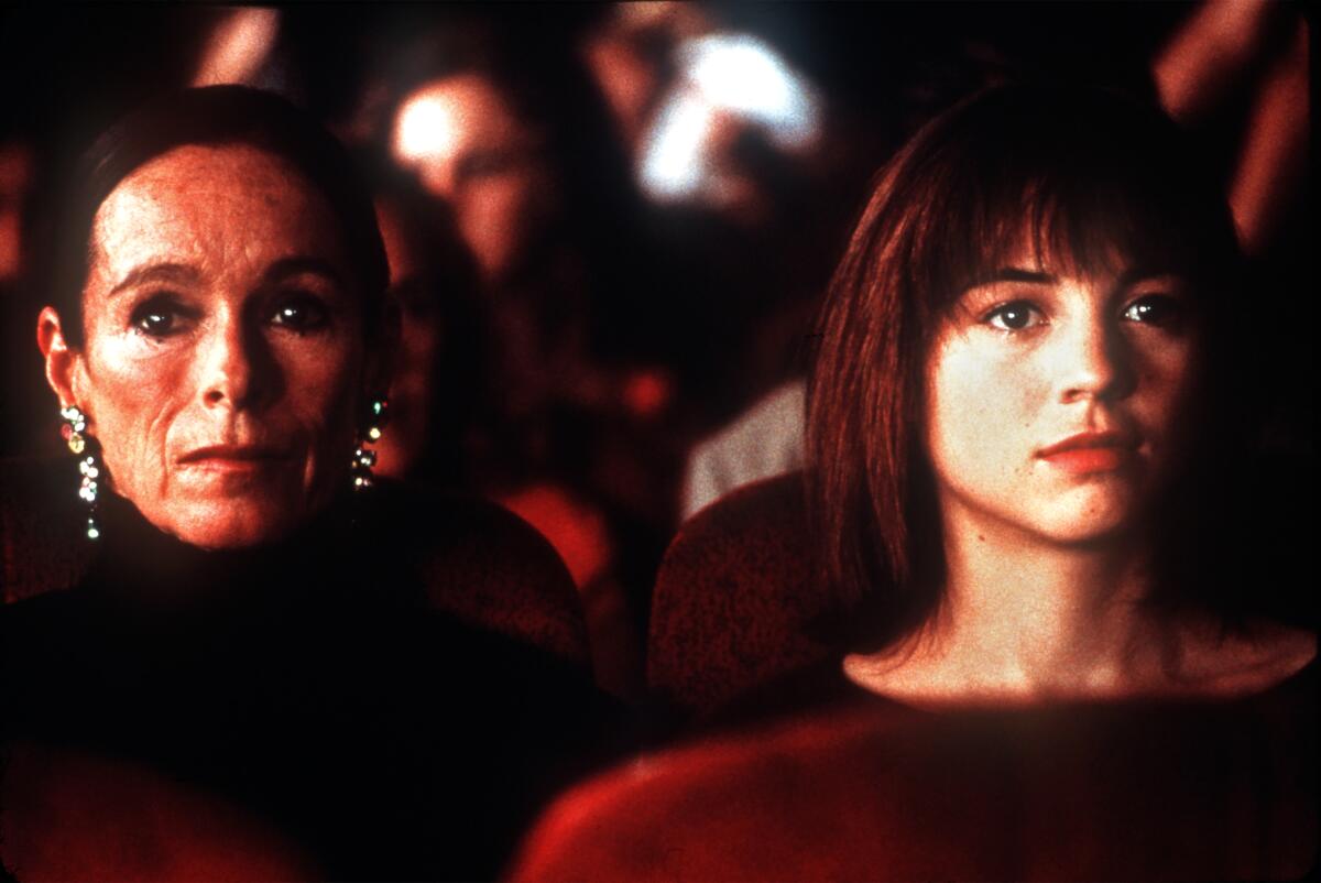 Geraldine Chaplin and Leonor Watling sit next to each other while looking forward in a scene from "Talk to Her."