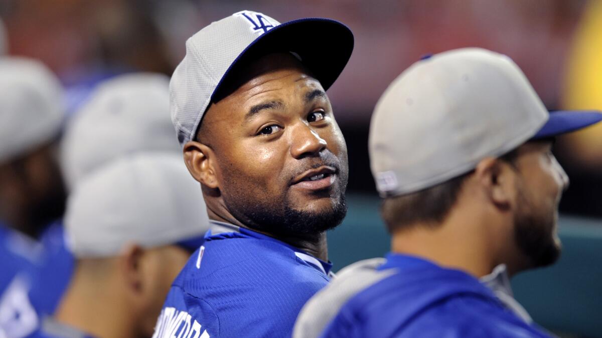 Dodgers outfielder Carl Crawford sits in the dugout during an exhibition game against the Angels at Angel Stadium on April 3.