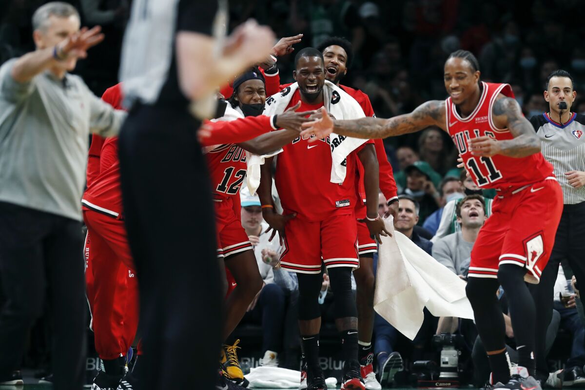 The Chicago Bulls bench reacts after a three-pointer by DeMar DeRozan (11) during the second half of an NBA basketball game against the Boston Celtics, Monday, Nov. 1, 2021, in Boston. (AP Photo/Michael Dwyer)