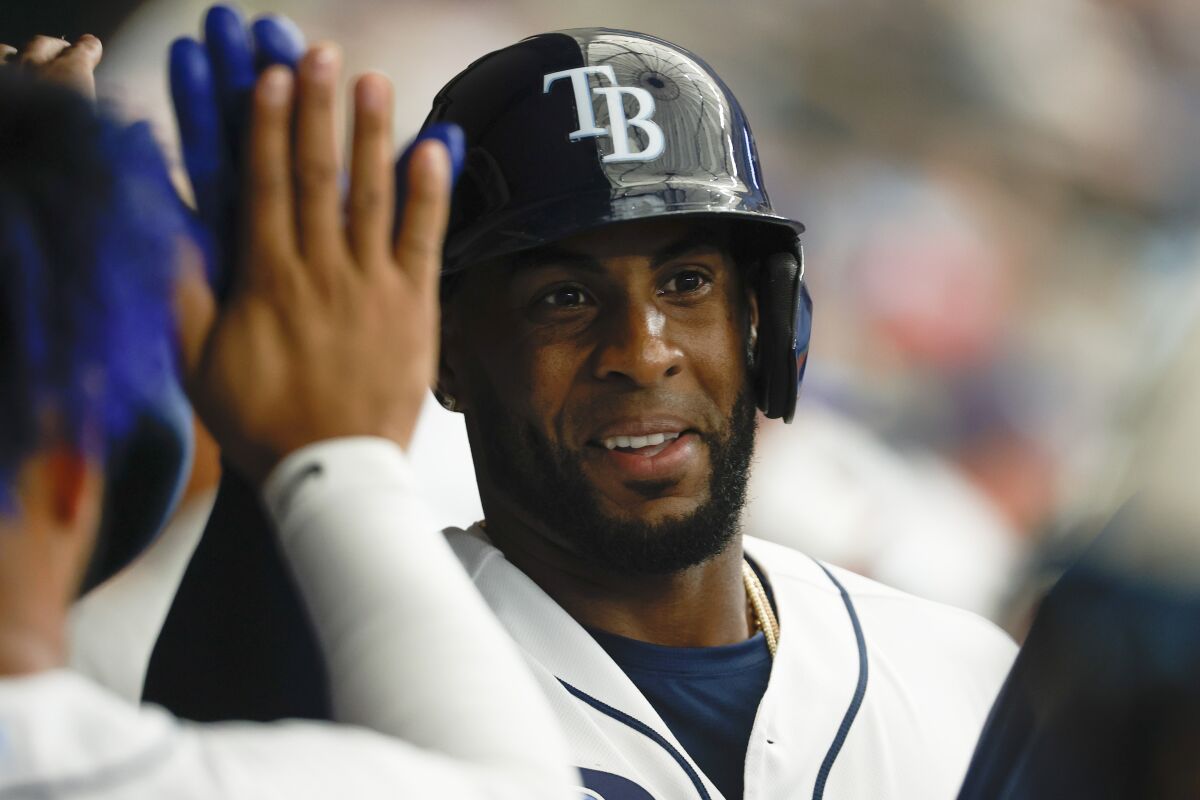 Tampa Bay Rays' Yandy Diaz celebrates with teammates after scoring against the Baltimore Orioles during the third inning of a baseball game Friday, April, 8, 2022, in St. Petersburg, Fla. (AP Photo/Scott Audette)