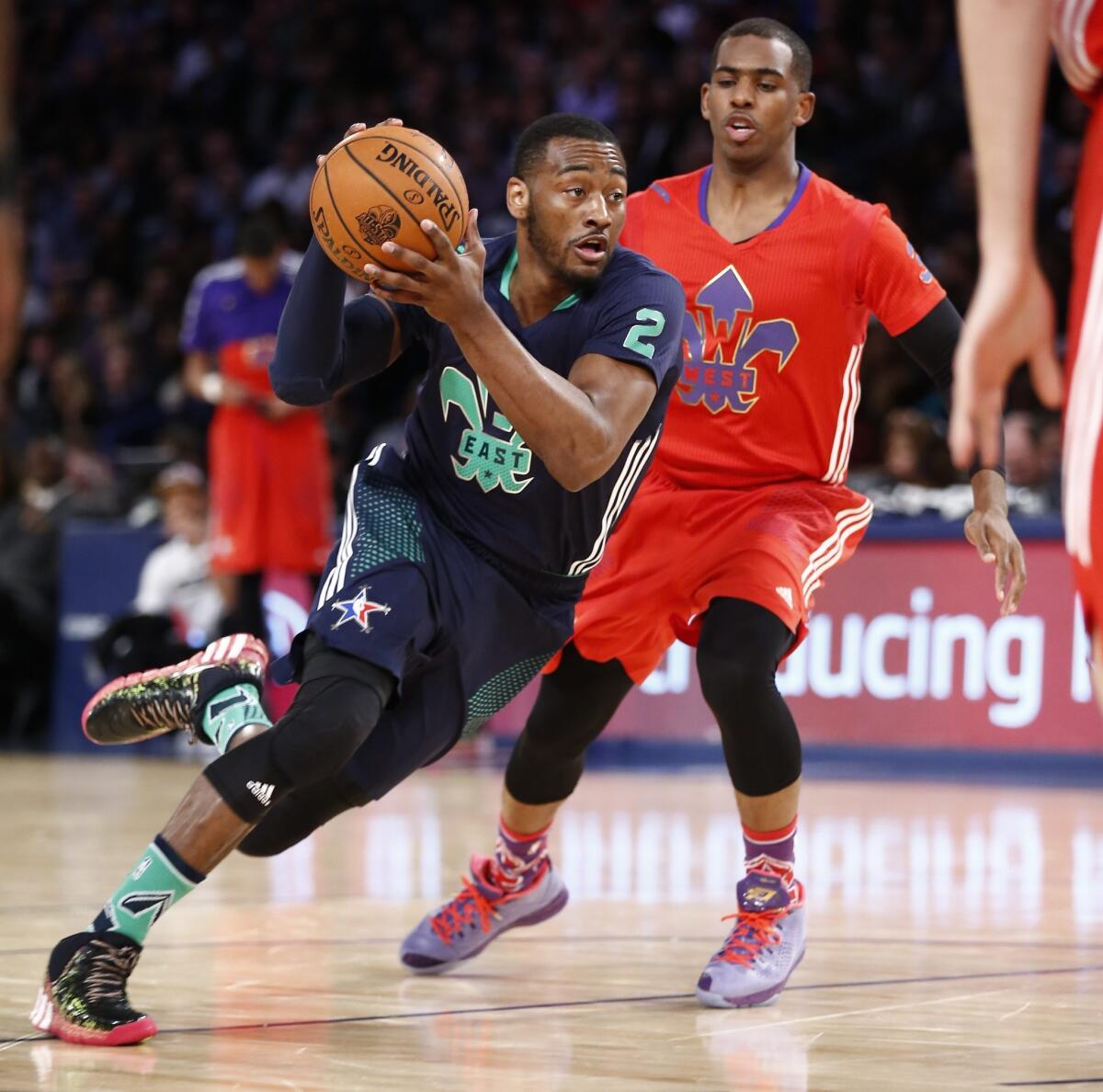 John Wall, left, driving past Chris Paul in the NBA All-Star game, is averaging 19.8 points and 8.8 assists for the Washington Wizards.