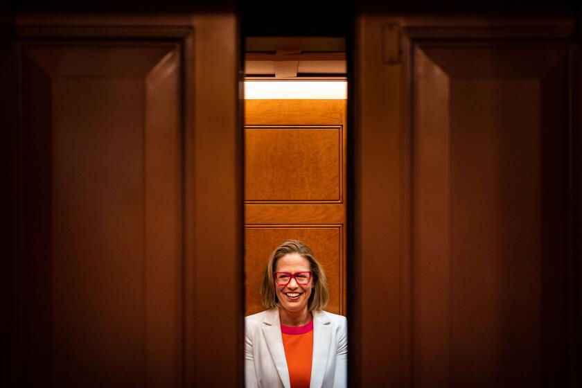 WASHINGTON, DC - NOVEMBER 16: Sen. Kyrsten Sinema (D-AZ) smiles while talking to reporters after leaving the Senate chamber following a procedural vote on federal legislation protecting same-sex marriages, on Capitol Hill on Wednesday, Nov. 16, 2022 in Washington, DC. (Kent Nishimura / Los Angeles Times)
