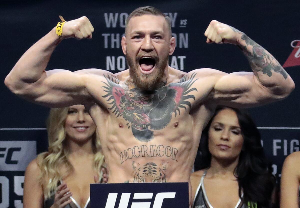 In this Nov. 11, 2016, file photo, Conor McGregor stands on a scale during the weigh-in event for his fight against Eddie Alvarez in UFC 205 mixed martial arts at Madison Square Garden in New York. Boxer Floyd Mayweather Jr. said Wednesday, June 14, 2017, he will come out of retirement to face UFC star Conor McGregor in a boxing match on Aug. 26. Mayweather, who retired in September 2015 after winning all 49 of his pro fights, will face a mixed martial arts fighter who has never been in a scheduled 12-round fight at the MGM Grand arena. The fight will take place in a boxing ring and be governed by boxing rules.