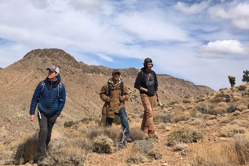 These photos were taken during a hike on Tuesday, March 9, 2021, into the roadless where K2 Gold Corp. of Vancouver, British Columbia is conducting exploratory drilling. From left, Bryan Hatchell, 27, spokesman for the nonprofit Friends of the Inyo, Jeremiah Joseph, spokesman for the Lone Pine Paiute Shoshone Tribe, Seth Tsosie, of the same tribe, walk where K2 Gold Corp. of Vancouver, British Columbia is conducting exploratory drilling.