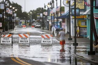 Flood water blocks a road Monday morning, Aug 5, 2024, in Tarpon Springs, Fla.