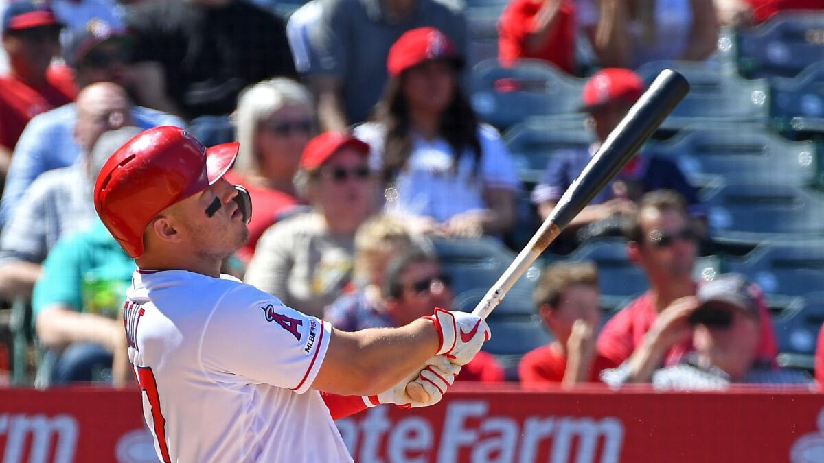Mike Trout of the Angels watches the flight of his grand slam in the fourth inning against the Texas Rangers at Angel Stadium.
