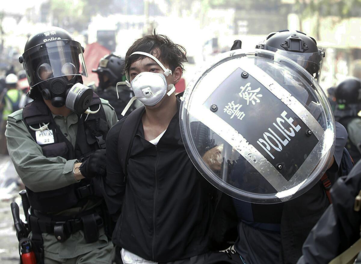Police officers detain a protester near Hong Kong Polytechnic University.