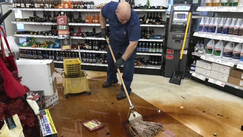 Randy Van Ness mops an aisle at Andy's Ace Hardware after a magnitude 7.0 earthquake struck Anchorage on Nov. 30.