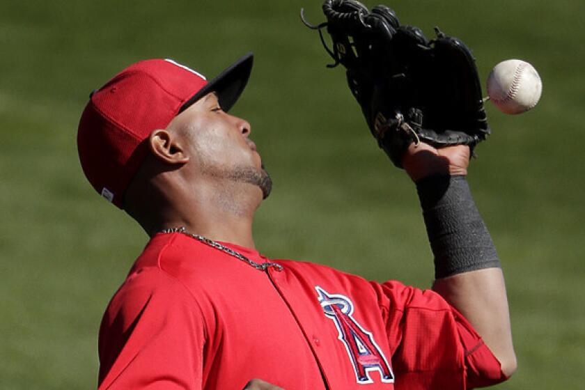 Luis Jimenez drops a fly ball during an Angels exhibition against the Mariners last month.