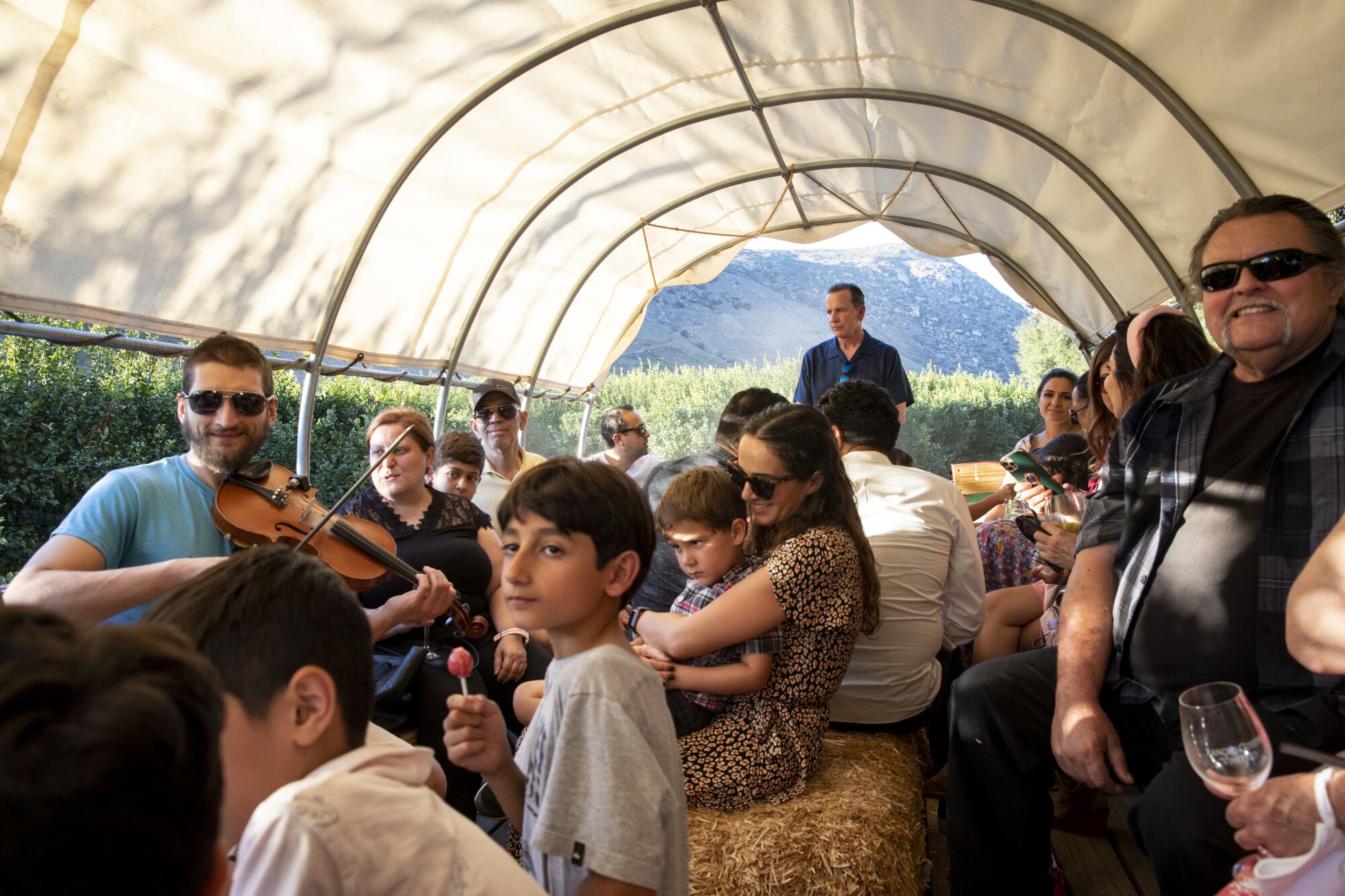 Friends and families listen to music during a hayride at the Rancho Guejito Vineyard in the San Pasqual Valley.