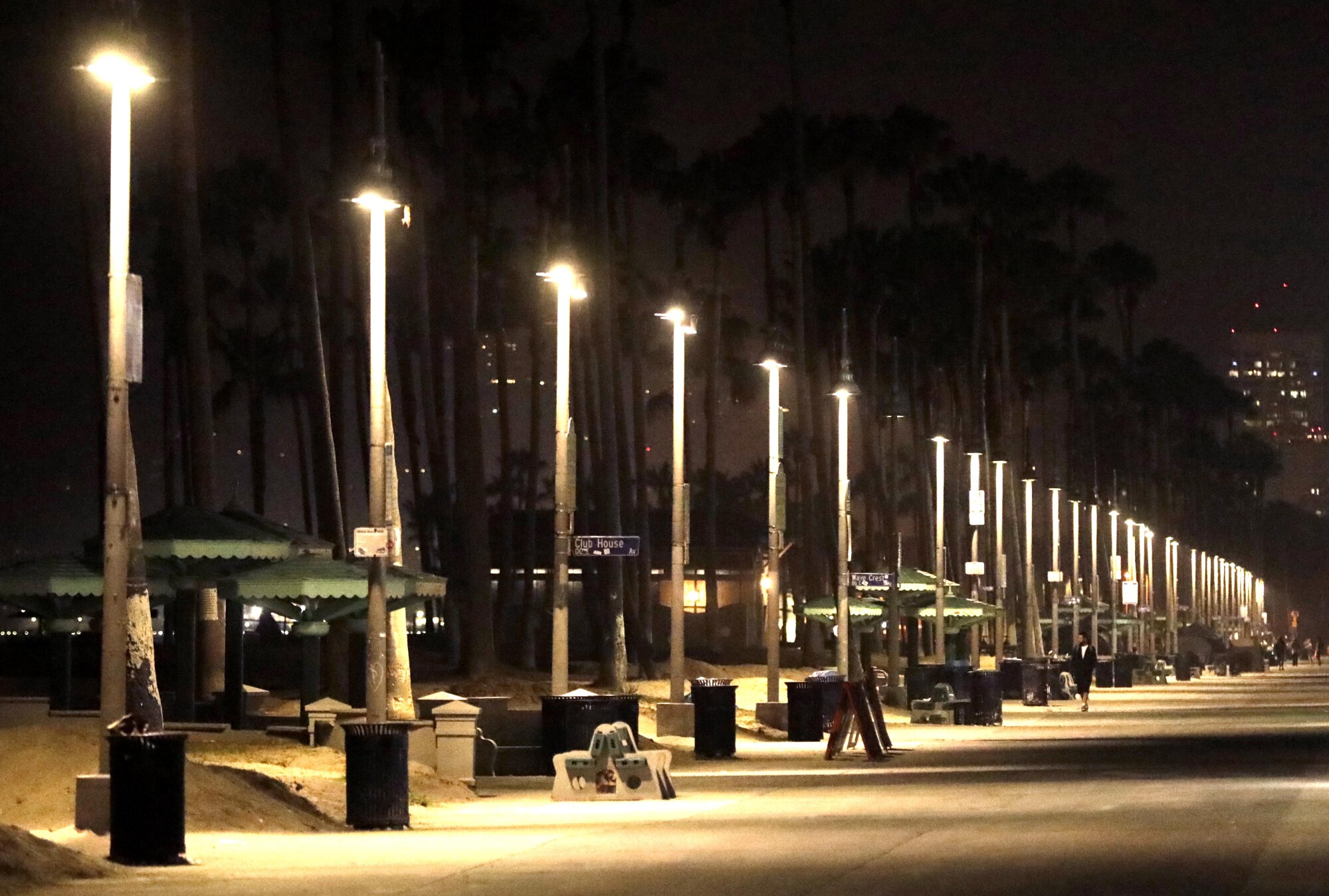 A man walks along a portion of Ocean Front Walk that has been cleared of homeless encampments in Venice.