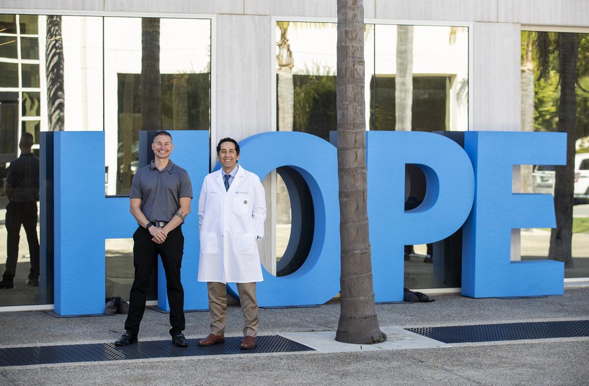 Will Godoy, left, and his oncologist Dr. Misagh Karimi at City of Hope Newport Beach.
