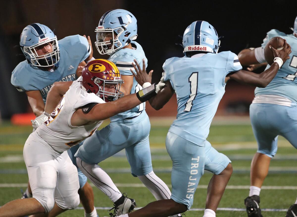 Estancia defender Roy Brown (19) gets into the backfield to tackle University's Justin Tribble (1) on Thursday.