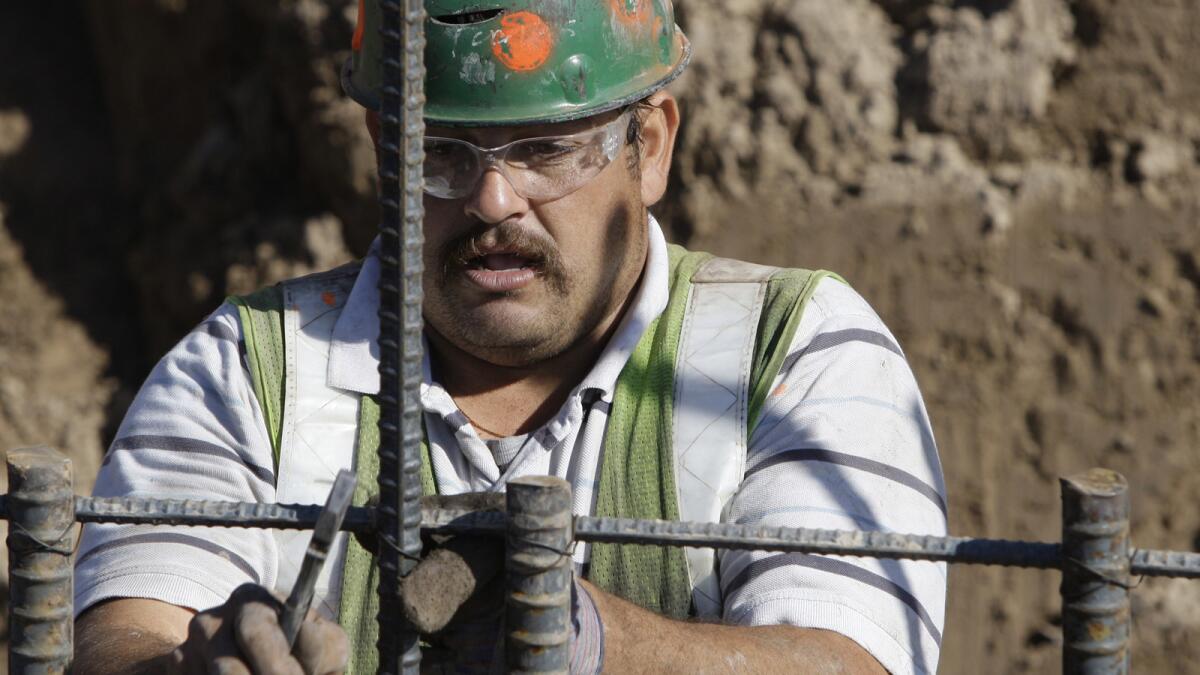 A worker connects rebar for the concrete foundation of the border wall in Granjeno, Texas, in February 2009.