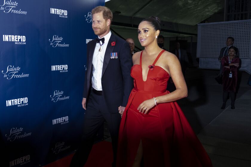 Prince Harry and Meghan Markle, Duke and Duchess of Sussex, arrive at the Intrepid Sea, Air & Space Museum for the Salute to Freedom Gala Wednesday, Nov. 10, 2021, in New York. The Duke of Sussex will also present the inaugural Intrepid Valor Award to five service members, veterans and their military families. (AP Photo/Craig Ruttle)