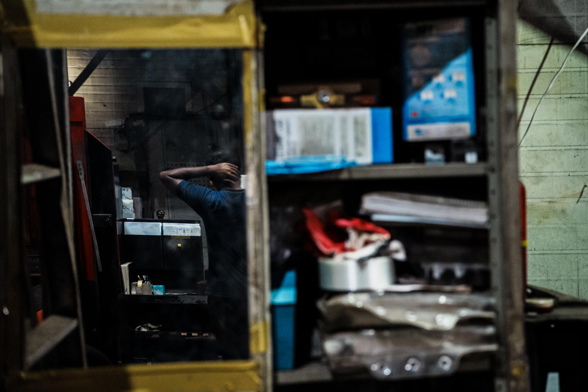 Foreign workers work inside a metal sheet production factory in an industrial area of Seoul.