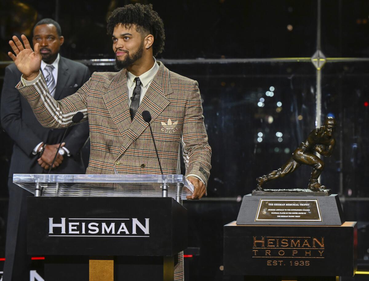 Caleb Williams waves after becoming the eighth USC player to win the Heisman Trophy.