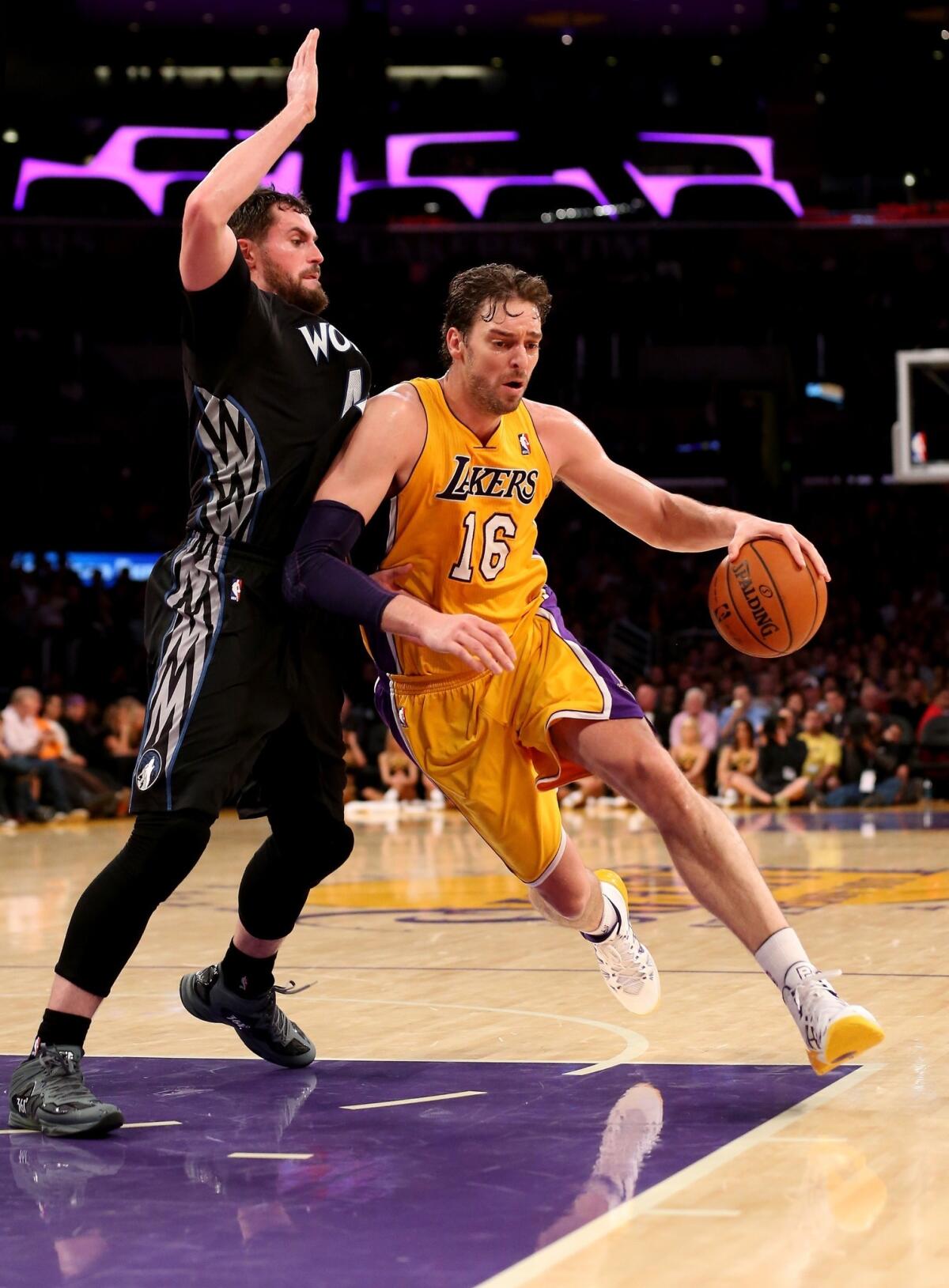 Lakers center Pau Gasol, right, drives around Minnesota Timberwolves forward Kevin Love during the Lakers' 104-91 win Friday. Gasol will not play in Saturday's game against the Golden State Warriors because of an upper respiratory infection.