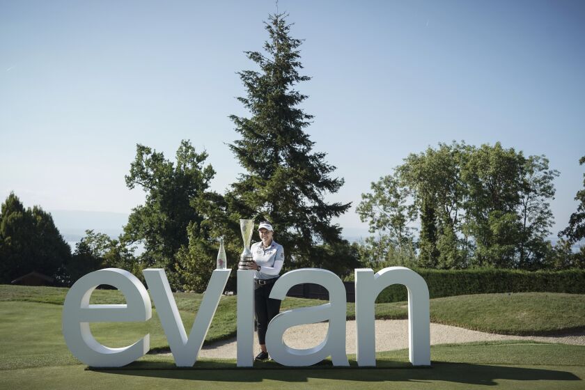 Brooke Henderson, of Canada, poses with her trophy after winning the Evian Championship women's golf tournament in Evian, eastern France, Sunday, July 24, 2022. (AP Photo/Laurent Cipriani)