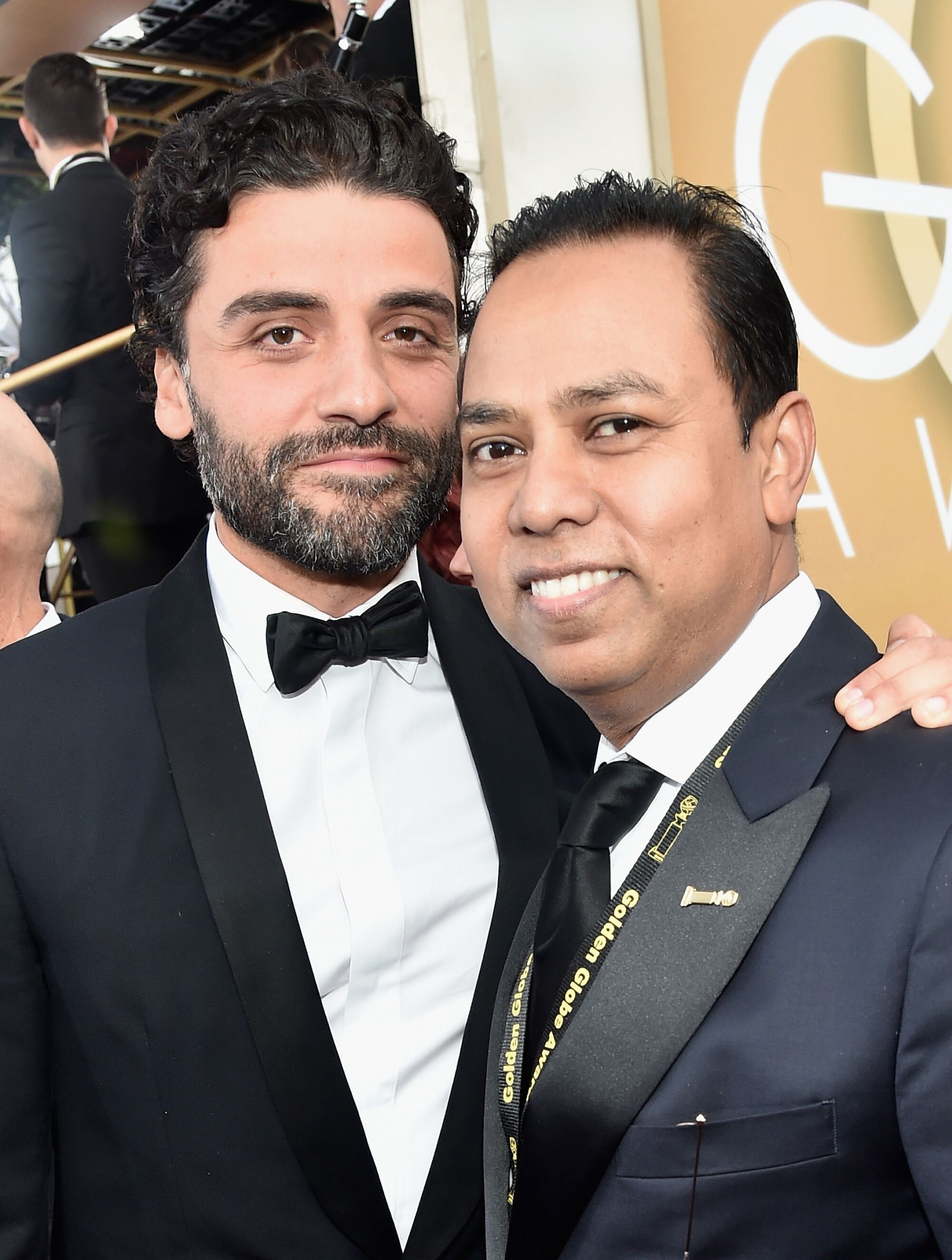 Actor Oscar Isaac and HFPA's Munawar Hosain pose for a photo at the Golden Globes red carpet