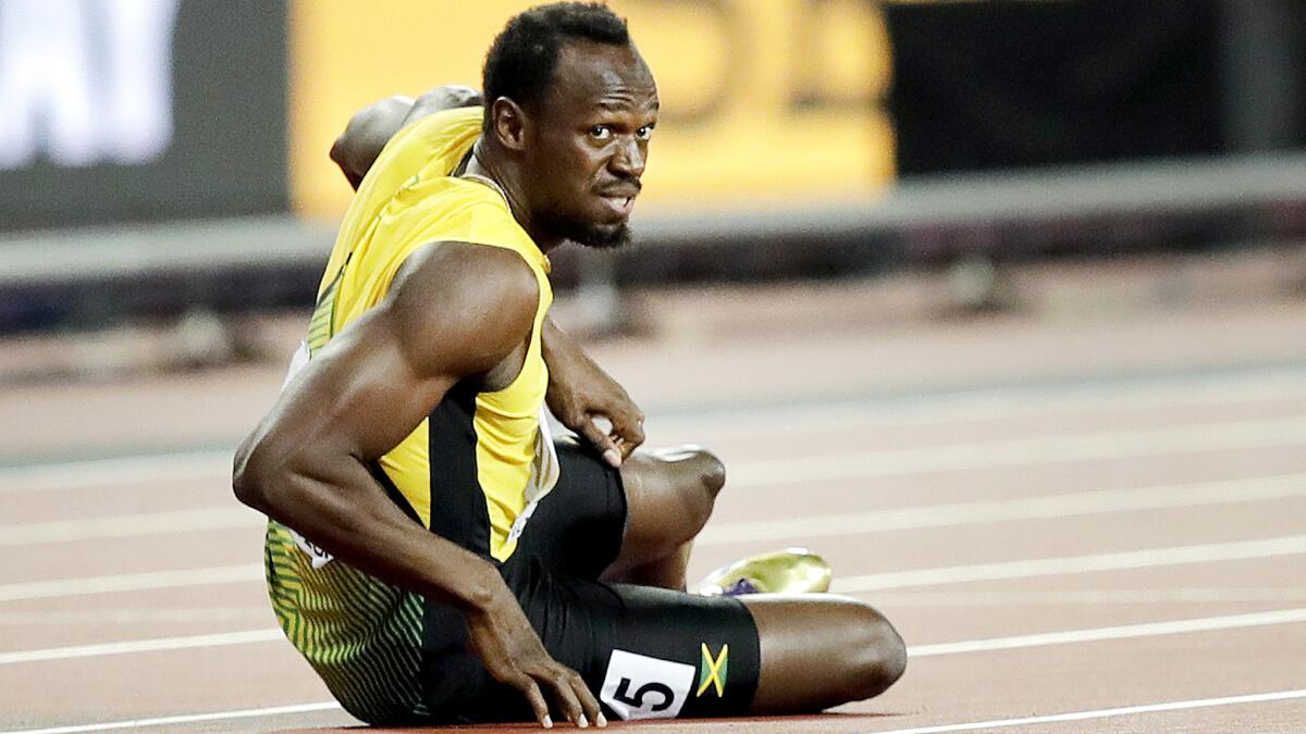 Usain Bolt lies on the track after he injured himself during the 400-meter relay final Saturday at the world championships.