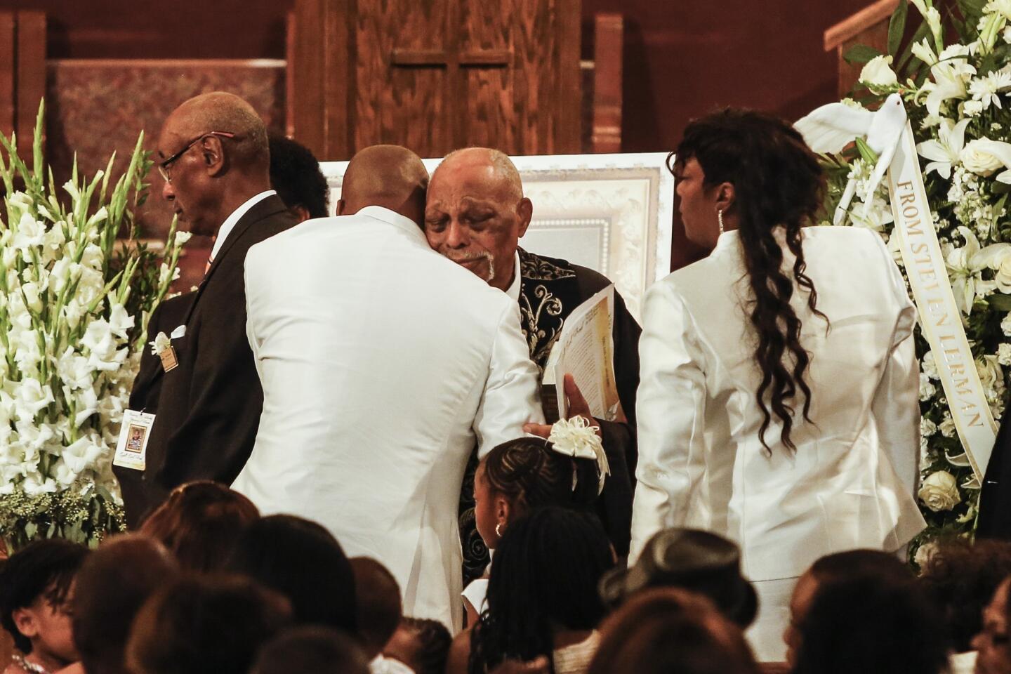 The Rev. Cecil "Chip" Murray, pastor emeritus at First African Methodist Episcopal Church, center, greets Edsell, left, and Tritobia Ford at the conclusion of the service.