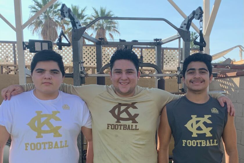 The Argott brothers, freshman Jesse (left), senior Frankie and sophomore Gabriel all play football for Granada Hills Kennedy and work out in their backyard.