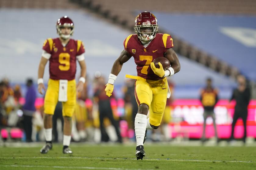 Southern California running back Stephen Carr, right, runs the ball from quarterback Kedon Slovis (9) during the third quarter of an NCAA college football game against UCLA Saturday, Dec 12, 2020, in Pasadena, Calif. (AP Photo/Ashley Landis)