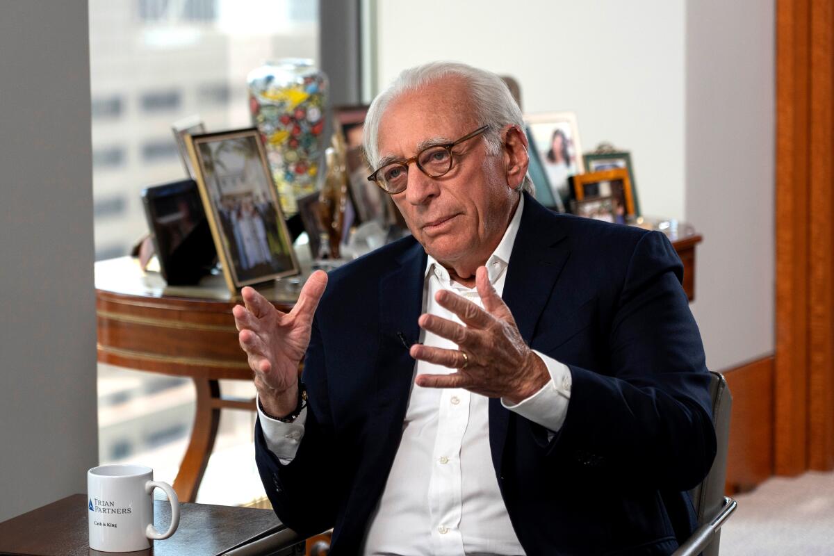 Nelson Peltz sits by a table and speaks.