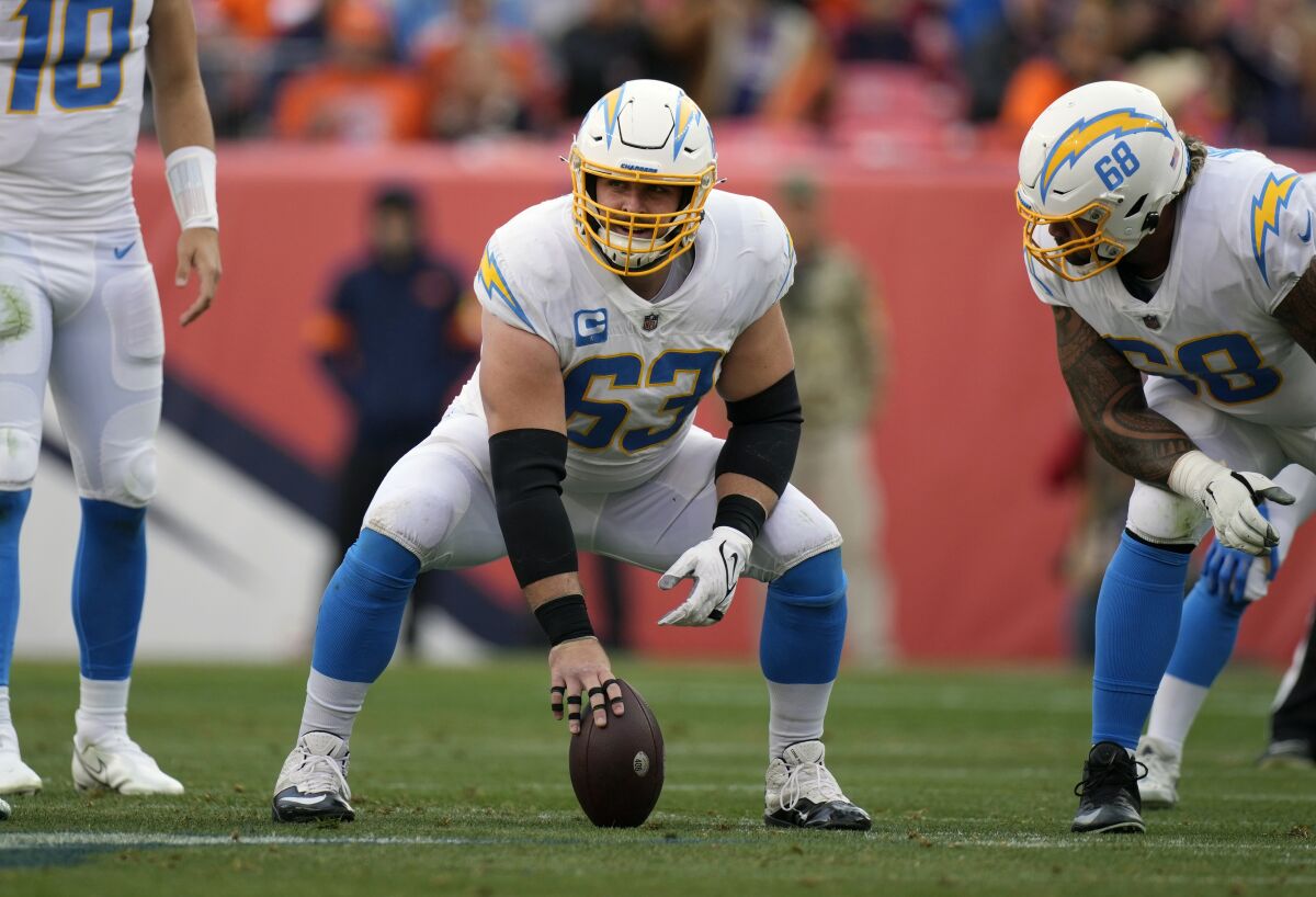 FILE - Los Angeles Chargers center Corey Linsley (63) against the Denver Broncos during the first half of an NFL football game, Sunday, Nov. 28, 2021, in Denver. Corey Linsley has made an impact on and off the field in his first season with the Los Angeles Chargers. Linsley, who signed with the Bolts in the offseason after seven seasons in Green Bay, has provided stability to the offensive line and is the team's nominee for the Walter Payton NFL Man of the Year award. (AP Photo/David Zalubowski, File)