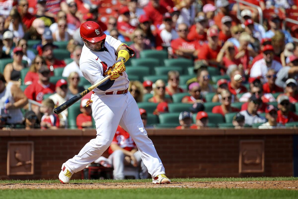 St. Louis Cardinals' Yadier Molina hits a two-run home run during the third inning in the first baseball game of a doubleheader against the Cincinnati Reds, Saturday, Sept. 17, 2022, in St. Louis. (AP Photo/Scott Kane)