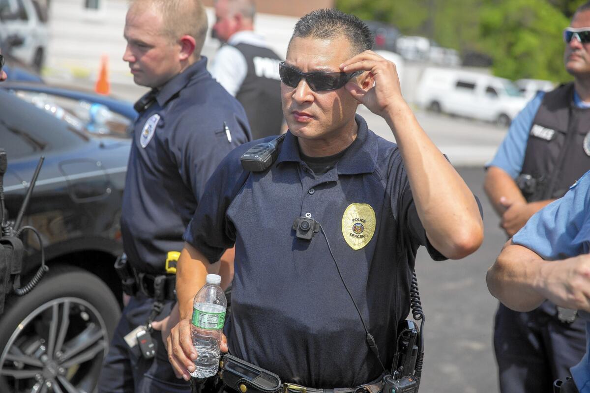 A police officer wears a body camera at a rally for Michael Brown in Ferguson, Mo. Brown, an unarmed black man, was shot and killed by Ferguson police in August. The department began equipping officers with body cameras after the shooting.