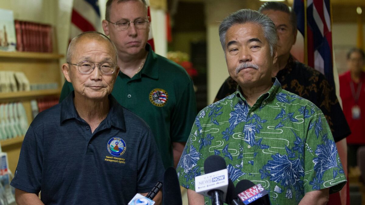 Hawaii Emergency Management Agency Administrator Vern Miyagi, left, and Gov. David Ige address the media Saturday at the HEMA center at Diamond Head Crater.