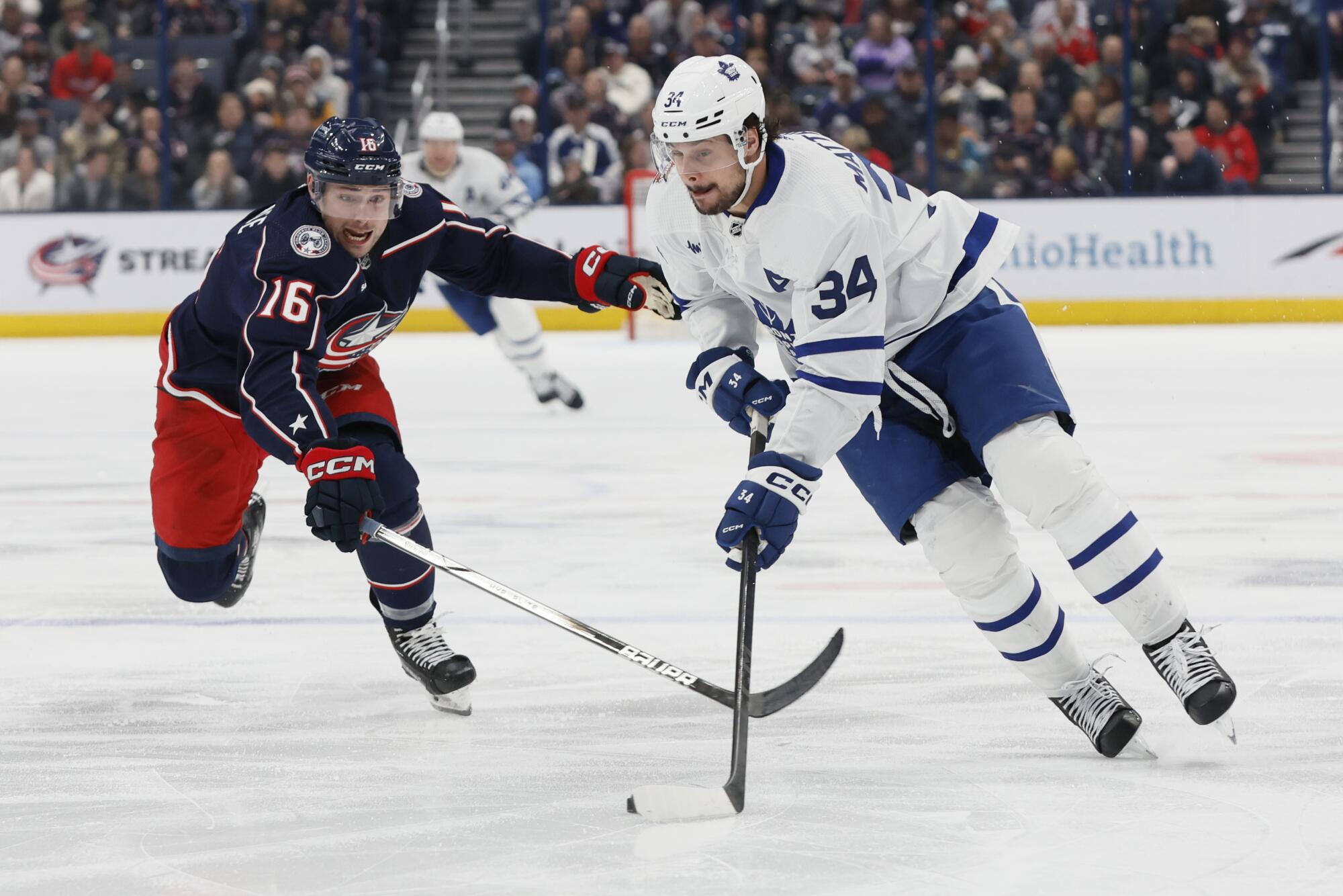 The Blue Jackets' Brendan Gaunce chases the Maple Leafs' Auston Matthews across the blue line during a game