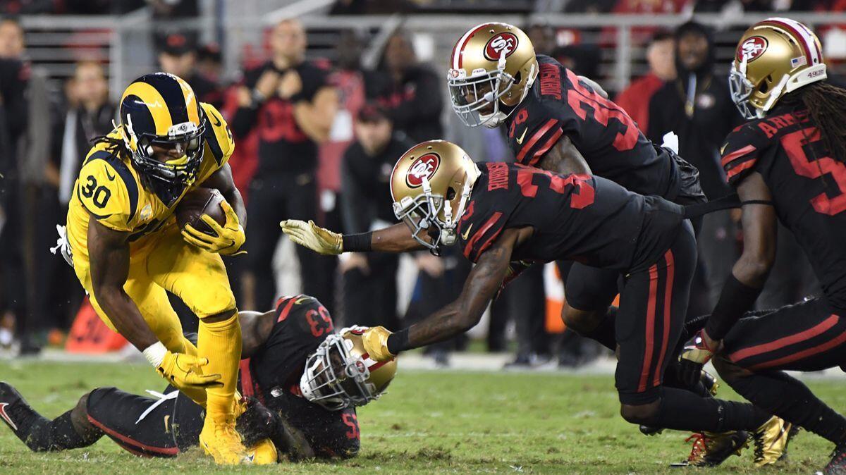 Rams running back Todd Gurley breaks away from four 49ers defenders to pick up yards in the fourth quarter at Levi's Stadium in Santa Clara on Thursday.