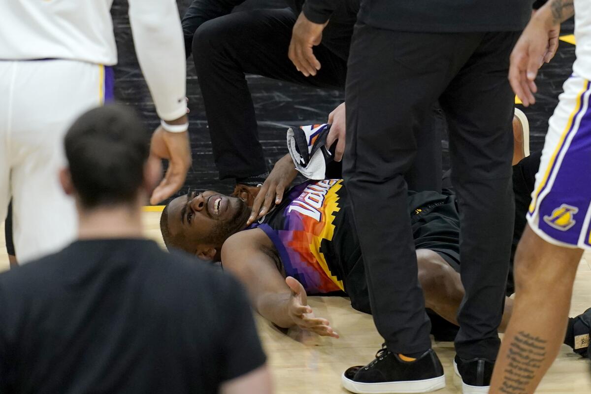 Phoenix Suns guard Chris Paul grimaces in pain during Game 1 against the Lakers on Sunday.