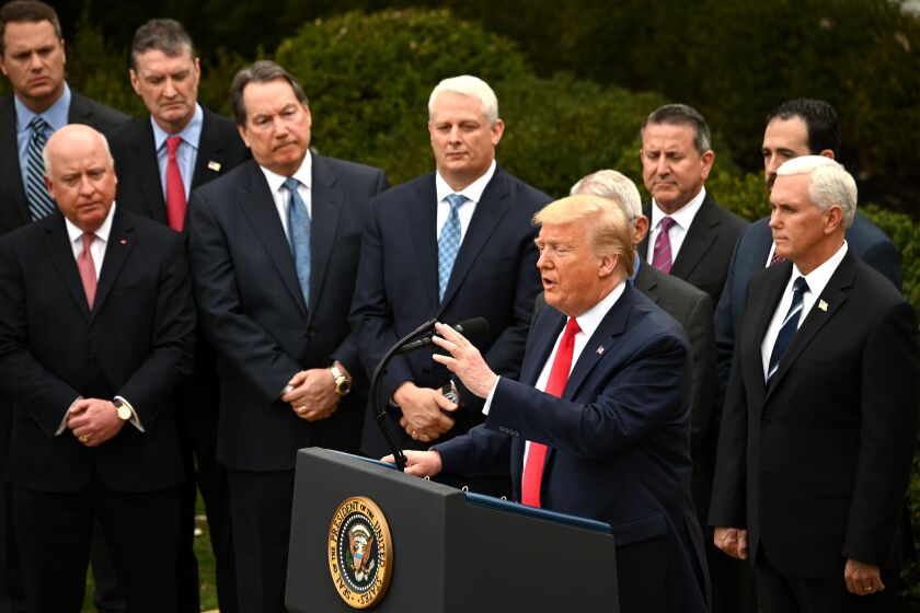 Surrounded by members of the White House Coronavirus Task Force, US President Donald Trump speaks at a press conference on COVID-19, known as the coronavirus, in the Rose Garden of the White House in Washington, DC, March 13, 2020. - US President Donald Trump declared the novel coronavirus, COVID-19, a national emergency on March 13, 2020. (Photo by JIM WATSON / AFP) (Photo by JIM WATSON/AFP via Getty Images)