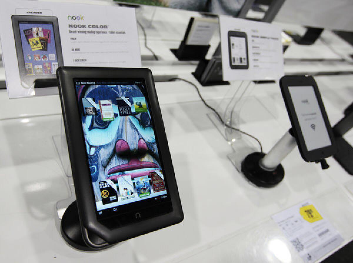 The Barnes & Noble Nook color tablet on display at a Best Buy next to the Nook simpletouch eReader.