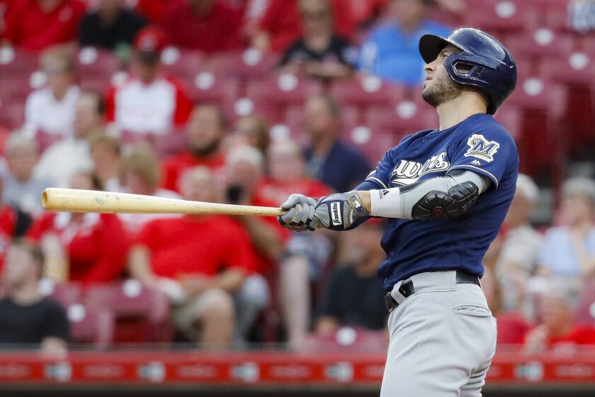 FILE - In this Sept. 25, 2019, file photo, Milwaukee Brewers' Ryan Braun watches his grand slam off Cincinnati Reds starting pitcher Tyler Mahle during the first inning of a baseball game in Cincinnati. Braun says he i “strongly leaning” toward retirement, but the Brewers’ home-run leader is not ready to make any decision regarding his future just yet. (AP Photo/John Minchillo, File)