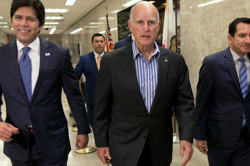 State Senate President Pro Tem Kevin de Leon, D-Los Angeles, from left, Gov. Jerry Brown and Assembly Speaker Anthony Rendon, D-Paramount, walk through the Capitol to a news conference to discuss the passage of a pair of climate change bills, Monday, July 17, 2017, in Sacramento, Calif. Brown backed the measures, which will extend the state's cap-and-trade program and aims to improve local air quality. (AP Photo/Rich Pedroncelli)