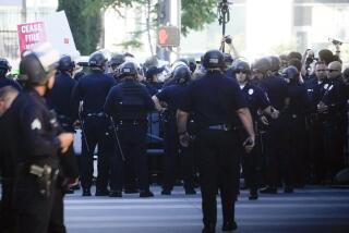 Law enforcement officers respond to protesters near the campaign event with President Joe Biden outside the Peacock Theater, Saturday, June 15, 2024, in Los Angeles. (AP Photo/Alex Brandon)