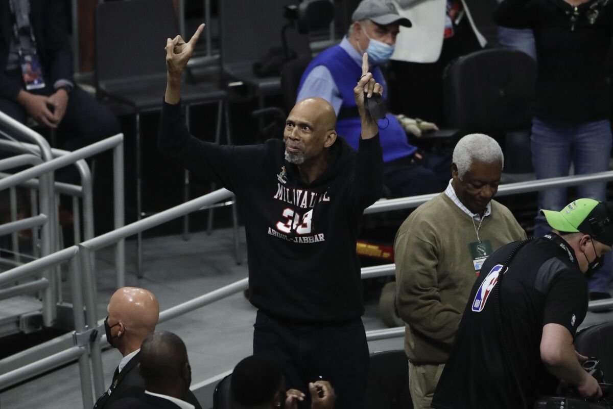 FILE -Kareem Abdul-Jabbar reacts during the first half of Game 4 of basketball's NBA Finals between the Milwaukee Bucks and the Phoenix Suns, Wednesday, July 14, 2021, in Milwaukee. Kareem Abdul-Jabbar's reign atop the NBA career scoring list is about to end after nearly four decades. LeBron James is on the verge of passing Abdul-Jabbar for the record that he's held since 1984.(AP Photo/Aaron Gash, File)