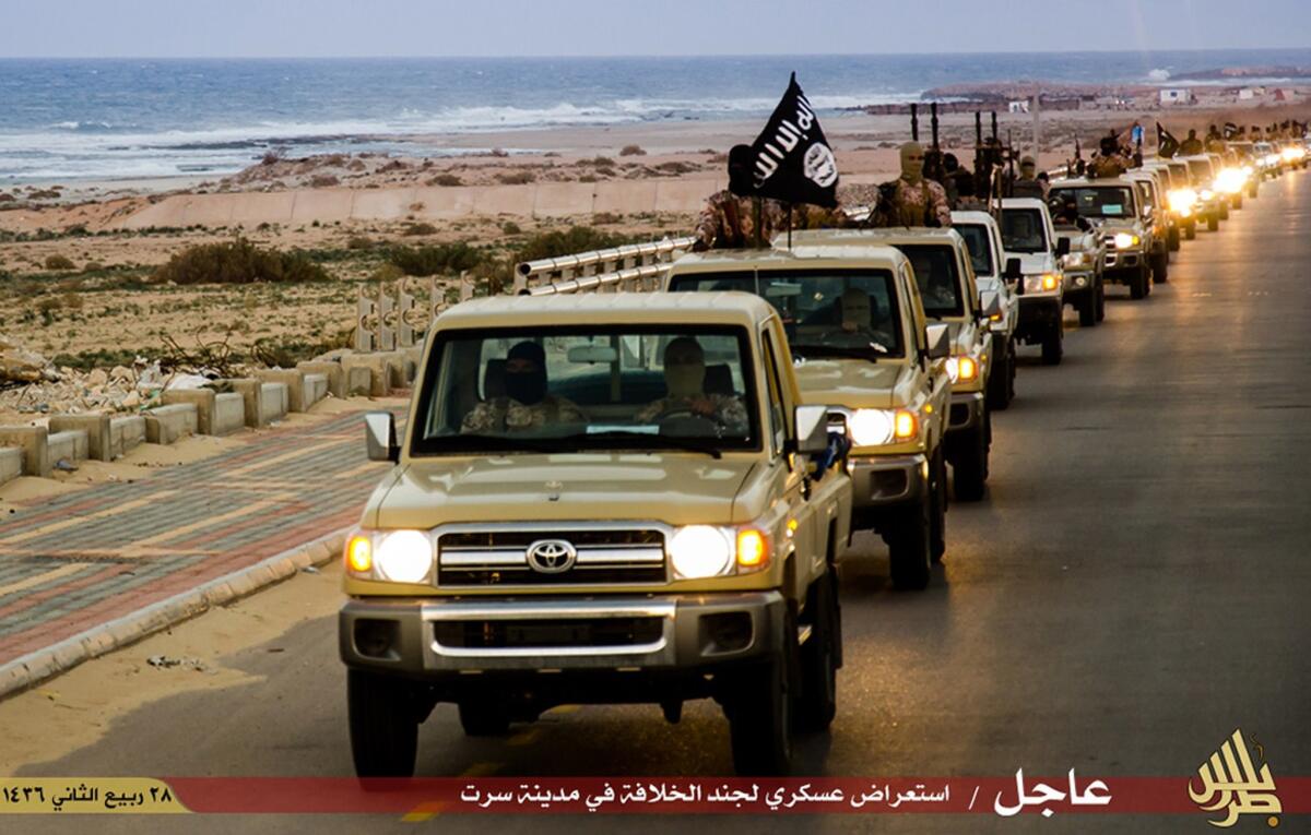 An image made available by an Islamist media outlet purportedly shows Islamic State militants parading in a street in Libya's coastal city of Sirte on Wednesday.