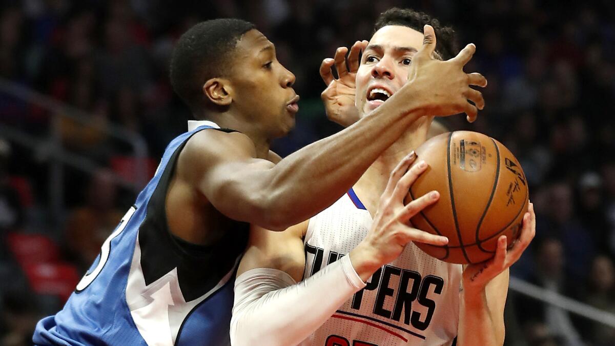 Clippers guard Austin Rivers tries to drive past Timberwolves guard Kris Dunn during the first half Thursday night.