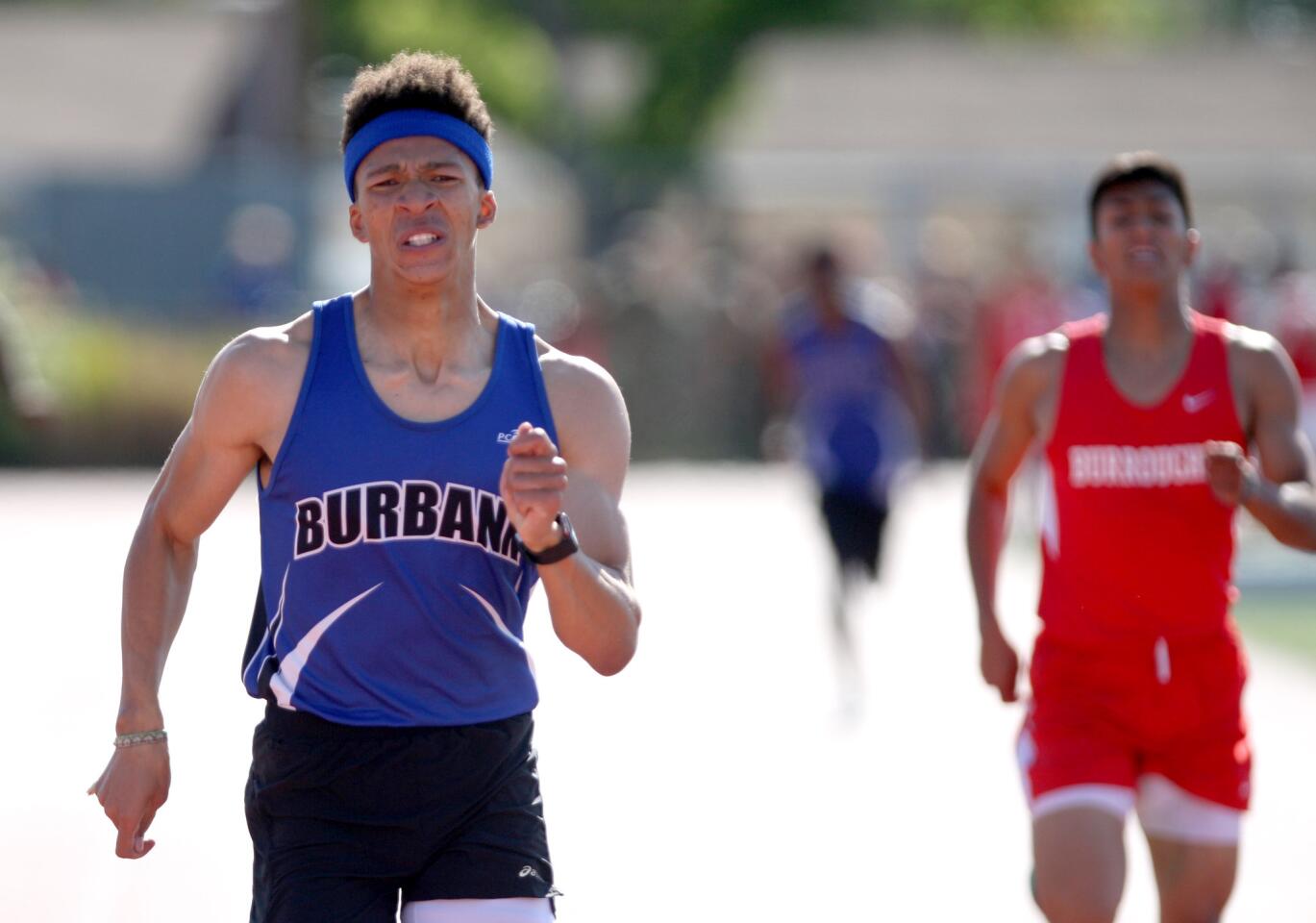 Burbank High School's runner Josh Cantong wins the 400-meter race vs. Burroughs High School at Burroughs in Pacific League track meet, in Burbank on Wednesday, April 20, 2016.