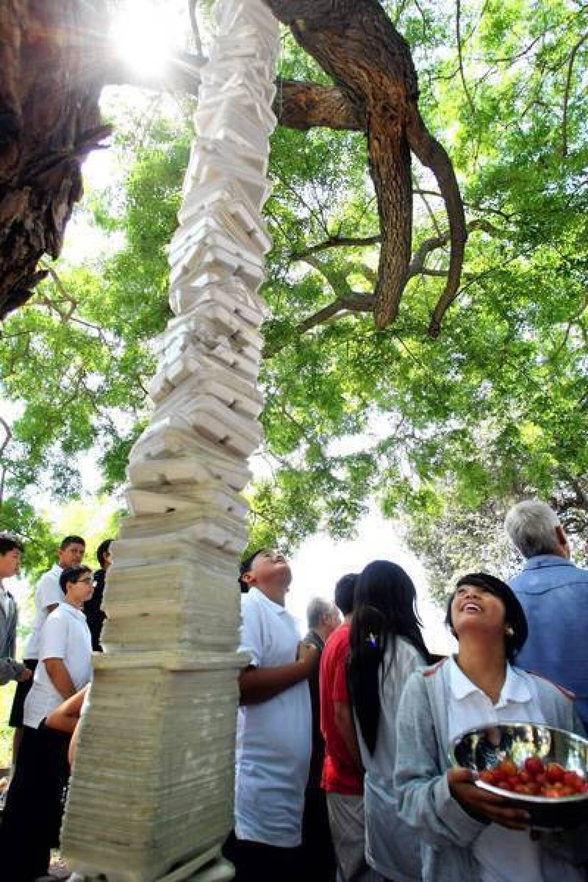 Students at Thomas Starr King Middle School in Los Feliz look up at a sculpture they made of 1,260 plastic foam cafeteria trays. The nonbiodegradable trays are being replaced with paper ones.