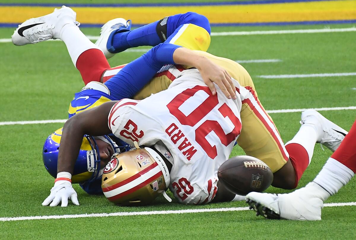 Rams quarterback Jared Goff fumbles as he is tackled by 49ers defensive back Jimmie Ward.